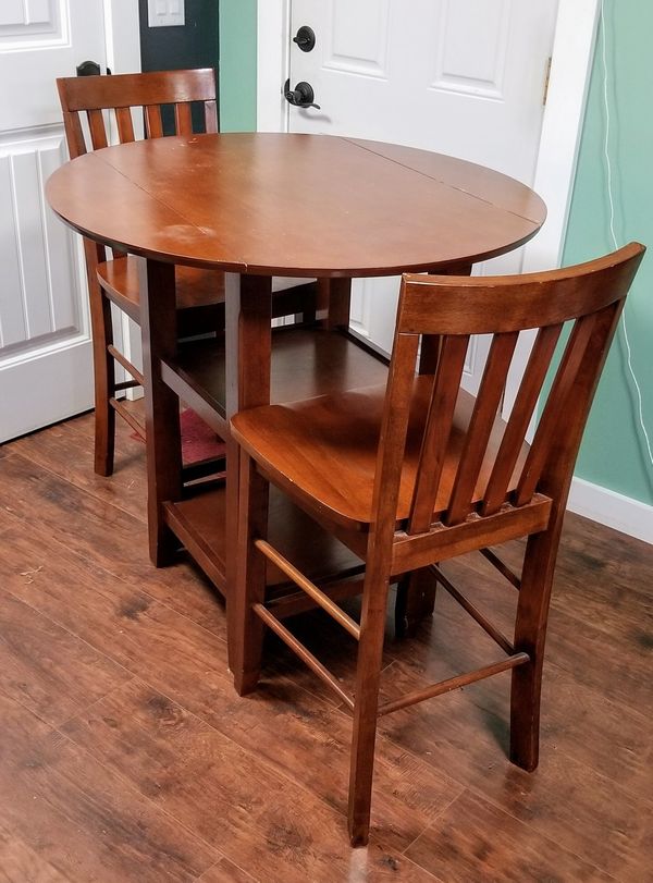 4 person Table with drop down sides, storage, and 2 chairs for Sale in