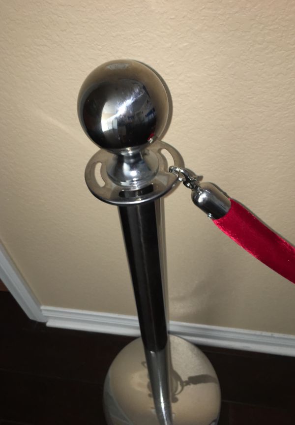 Pair of chrome red carpet poles with one red rope for Sale in Chula