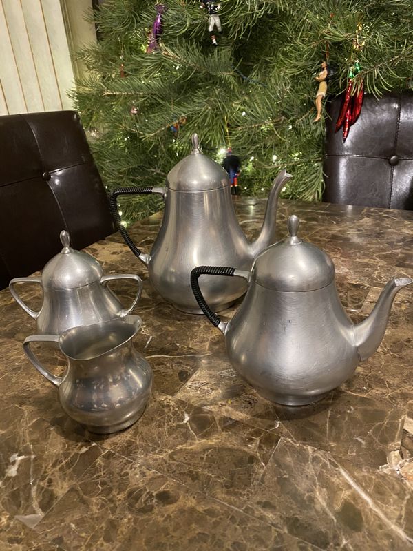 This is a 4 Piece pewter coffee and tea set with creamer and sugar. The