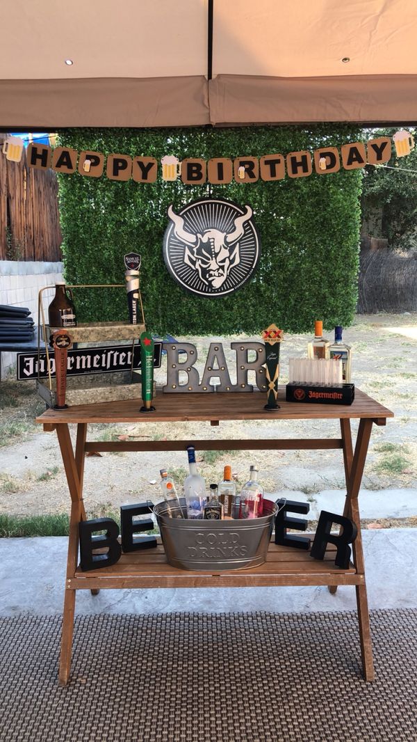 Cheers and Beers Party decor with boxwood backdrop for