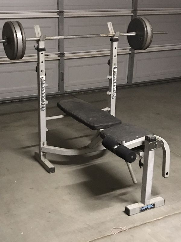 Weights, bench, bar, and over 350 pounds of iron plates. Different size