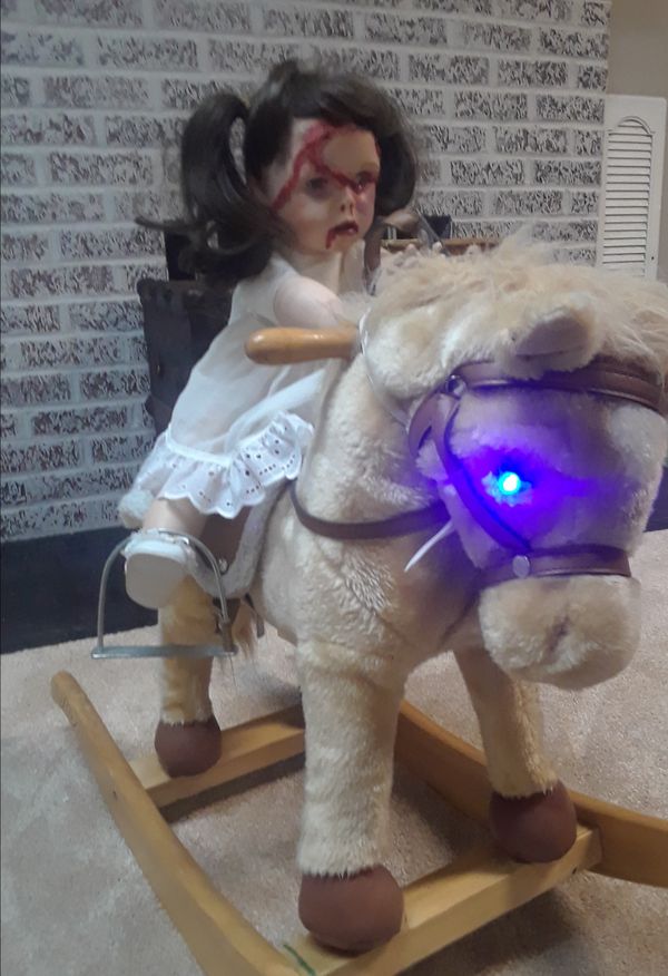 animated demon doll on rocking horse