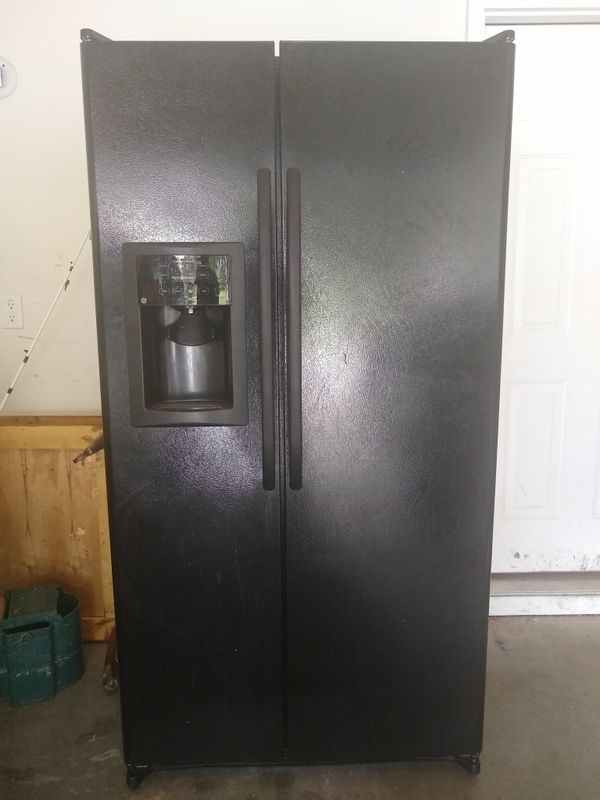 70 GE black, side by side refrigerator. Used! Clean! Needs repair