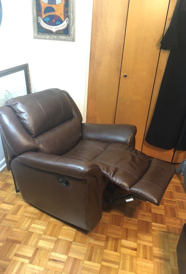 Brown vinyl rocker recliner in pristine (hardly used) condition. for