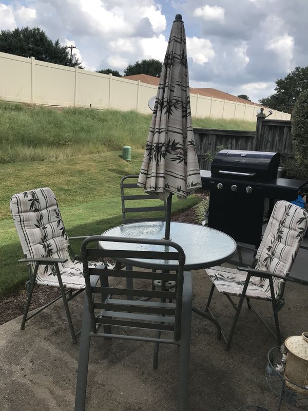 patio table with umbrella and 4 chairs