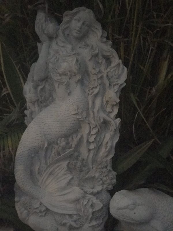 large concrete mermaid statue