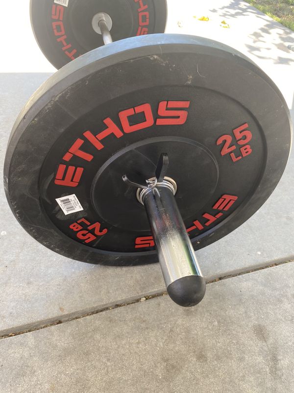Ethos 25 pounds bumper plates with olympic curl bar for Sale in Los