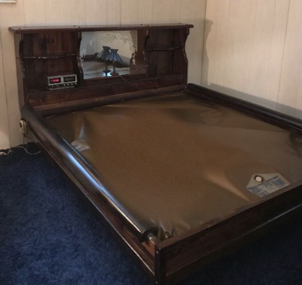 King waterbed frame with new mattress in box and new heater in box for