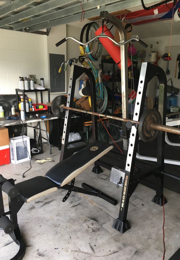 Golds gym bench and rack with Olympic bar and 50lbs Olympic Weights for ...