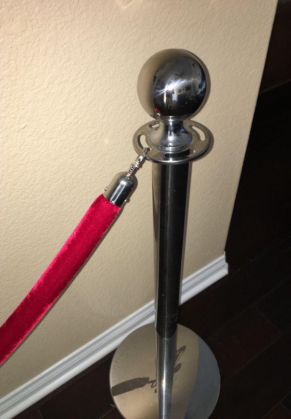 Pair of chrome red carpet poles with one red rope for Sale in Chula