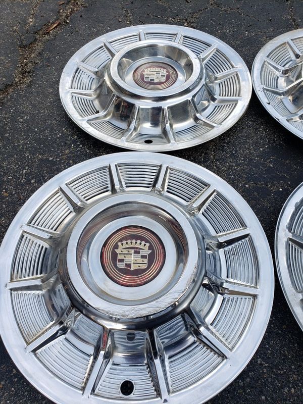 Original 1957 Cadillac Hubcaps with 2 good centers. They have some