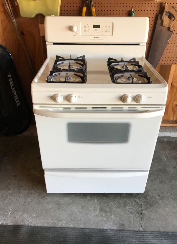 Bisque color 4 burner Kenmore stove with warming drawer and matching