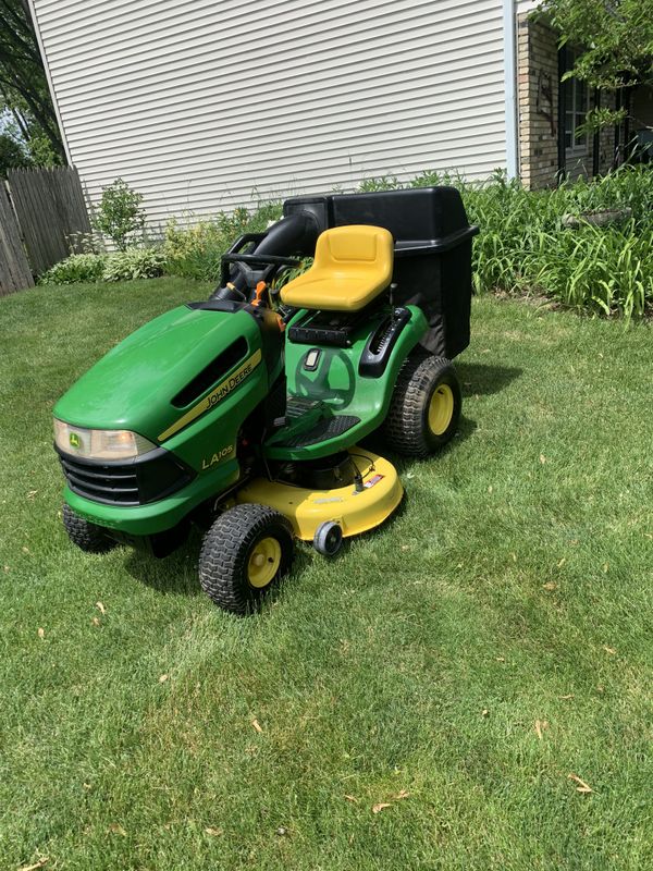 Like new John Deere LA105 riding lawn mower with bagger. 67 hours for